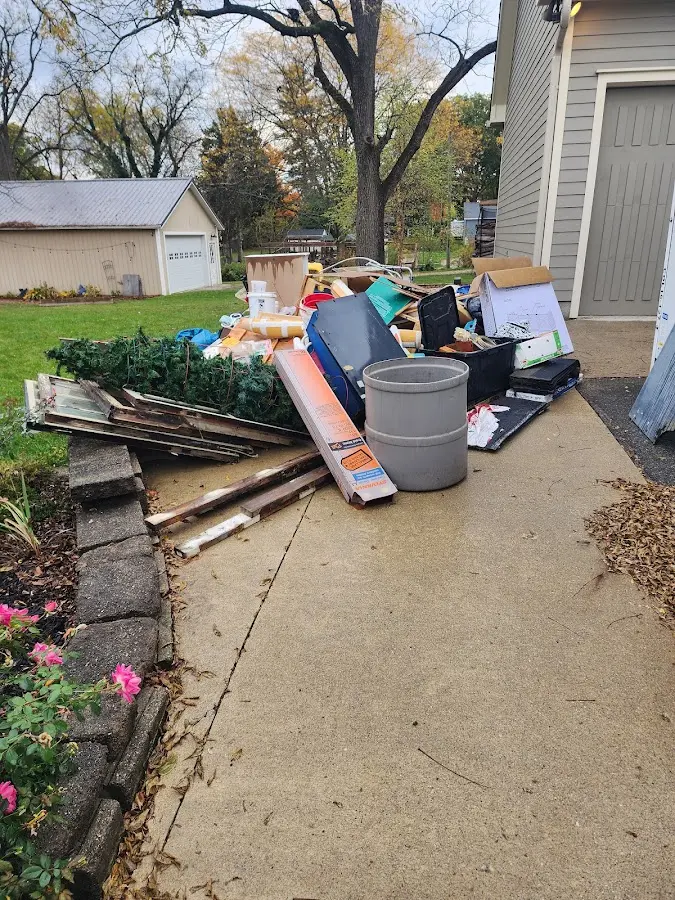 Dumpster being loaded with debris for Roofing Dumpster Rental in Ave Maria